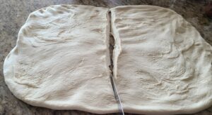 sourdough bread dough divided in half to be shaped into loaves