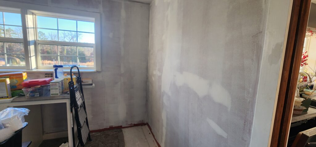 patched and primed laundry room walls ready for paint