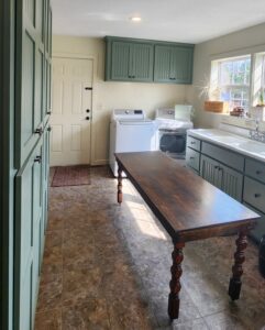 completed laundry room remodel with green cabinets