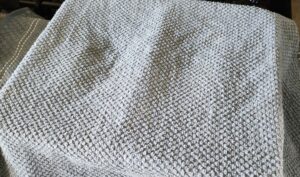 loaves of bread covered with damp towel to rise