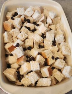bread pieces and raisins in baking dish