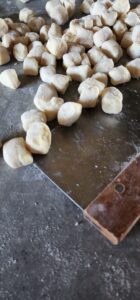 cut fresh gnocchi and a dough scraper