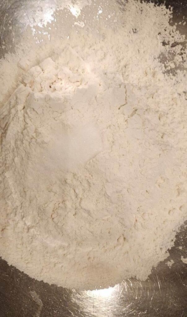 Flour and salt in a steel mixing bowl