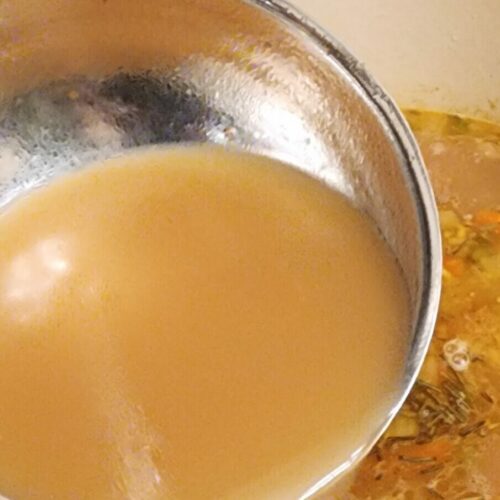 ladle of chicken broth