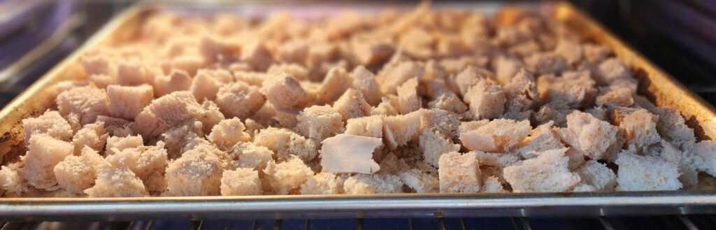 bread cubes baking in an oven